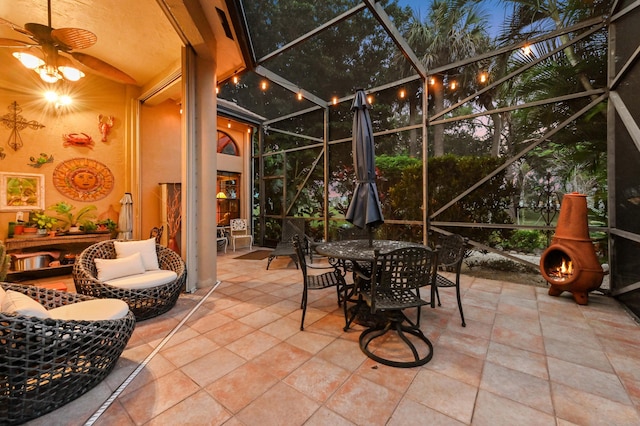 sunroom with ceiling fan and vaulted ceiling