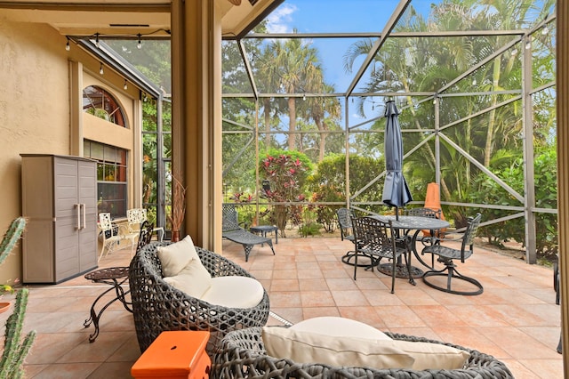 view of patio with glass enclosure