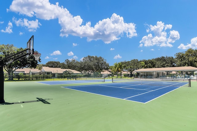 view of tennis court featuring basketball hoop