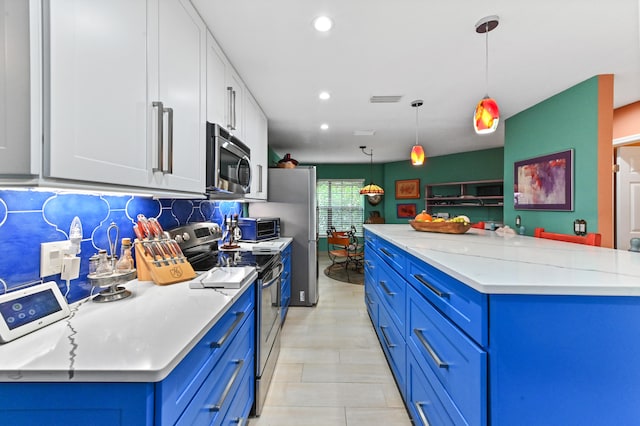 kitchen with blue cabinets, white cabinets, decorative light fixtures, and appliances with stainless steel finishes