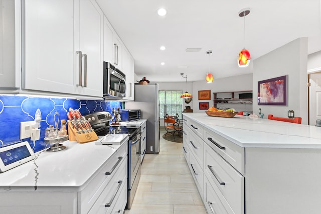 kitchen with white cabinetry, a center island, hanging light fixtures, backsplash, and appliances with stainless steel finishes