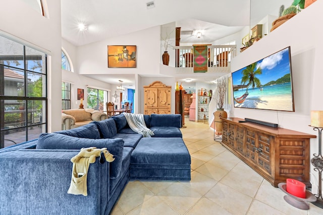 tiled living room with plenty of natural light and high vaulted ceiling