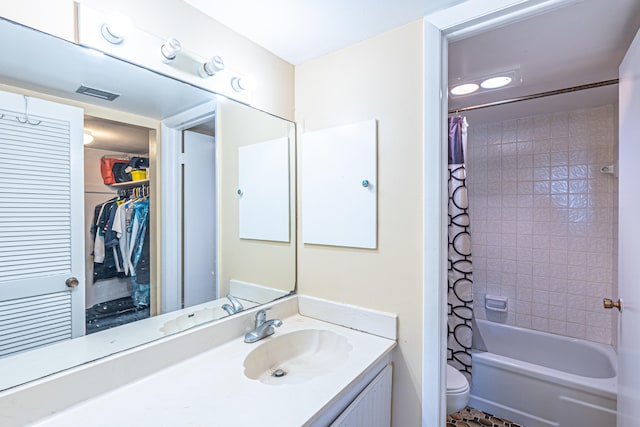 full bathroom with shower / tub combo with curtain, vanity, and toilet