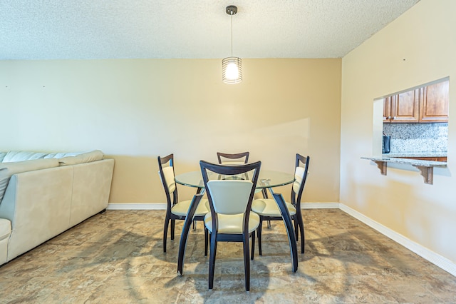 dining space with a textured ceiling