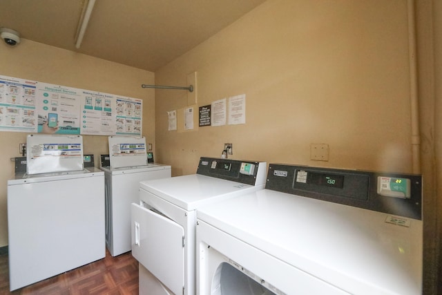 washroom featuring washer and dryer and dark parquet floors