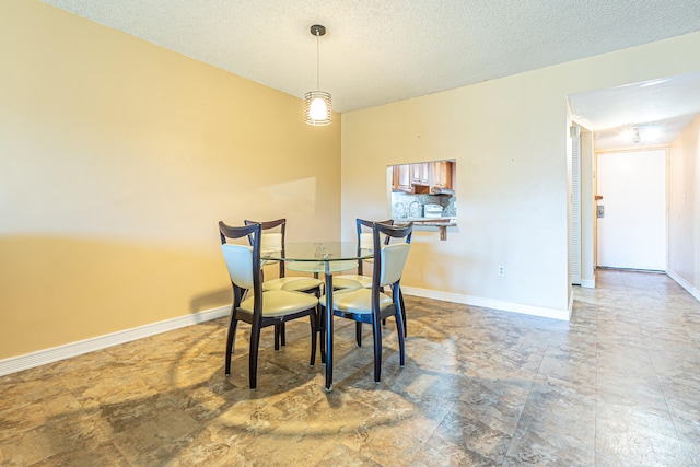 dining room featuring a textured ceiling