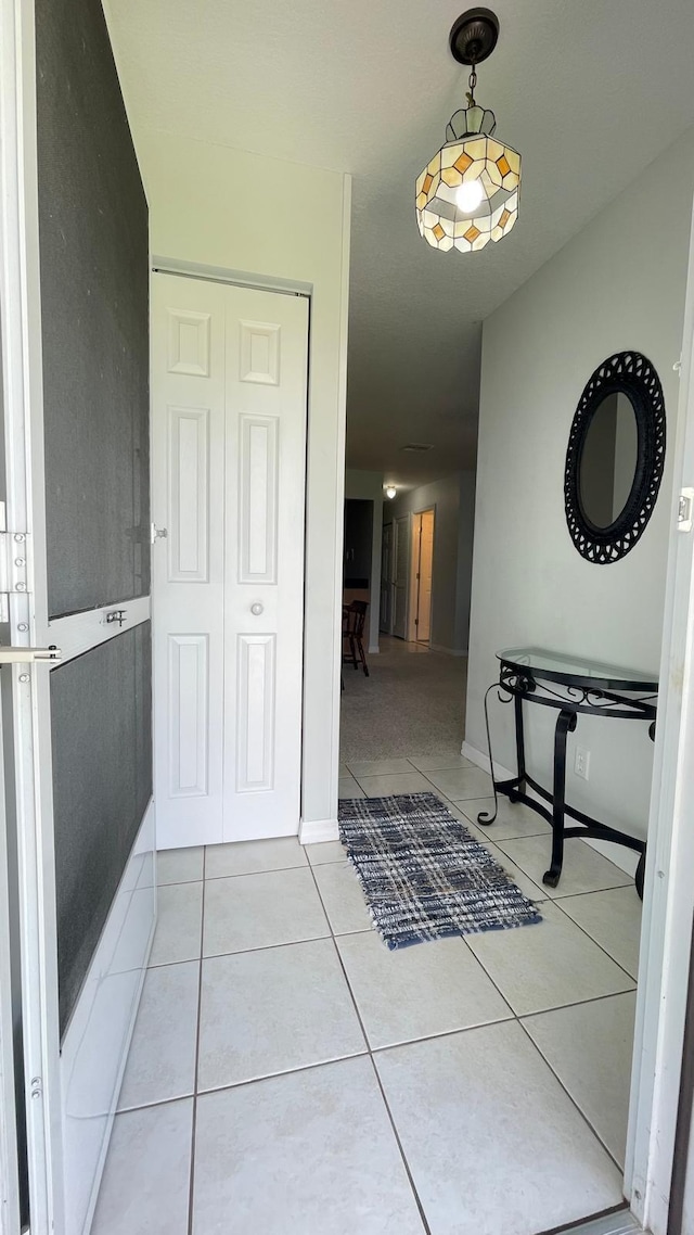 hallway with light tile patterned floors