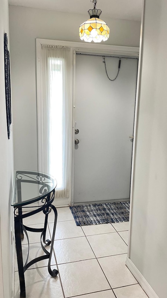 doorway featuring light tile patterned flooring