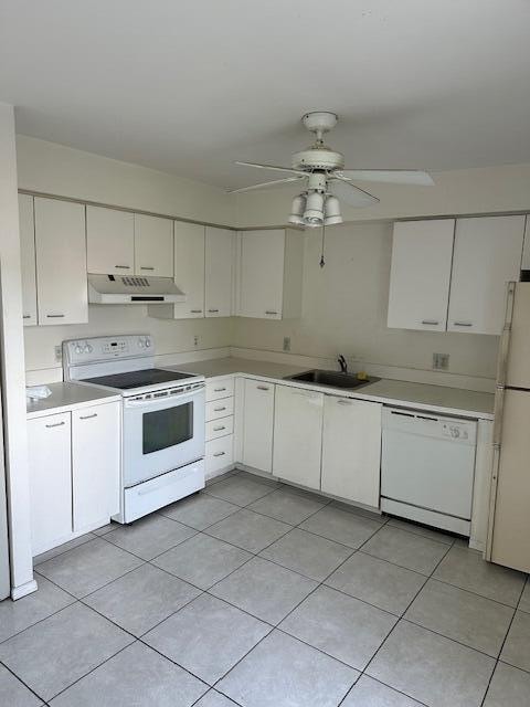 kitchen with white cabinetry, ceiling fan, sink, white appliances, and light tile patterned floors