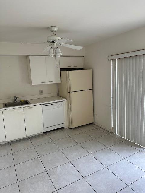 kitchen with white cabinetry, white appliances, sink, and light tile patterned floors