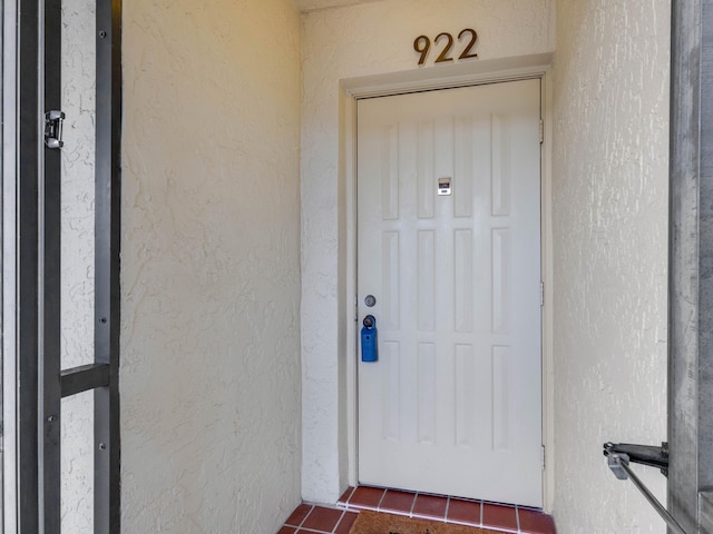 entrance to property featuring stucco siding