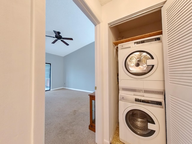 washroom with laundry area, a ceiling fan, baseboards, stacked washer / drying machine, and carpet