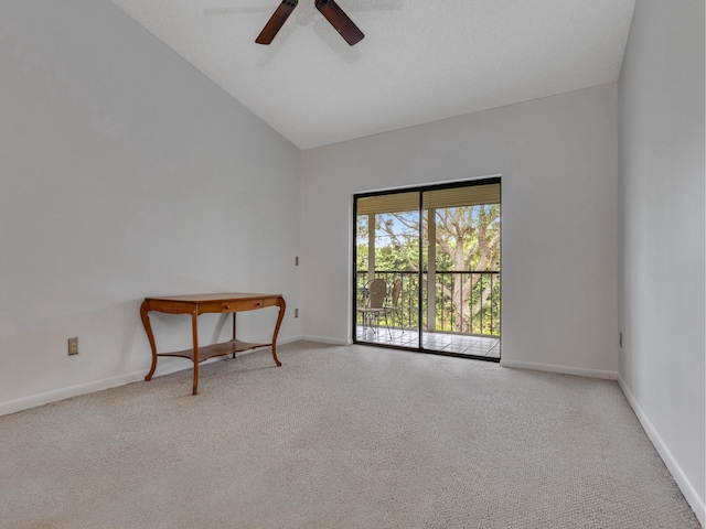 carpeted spare room featuring high vaulted ceiling, ceiling fan, and baseboards