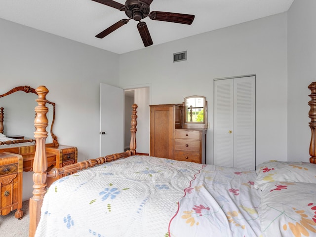 carpeted bedroom with a ceiling fan, a closet, and visible vents