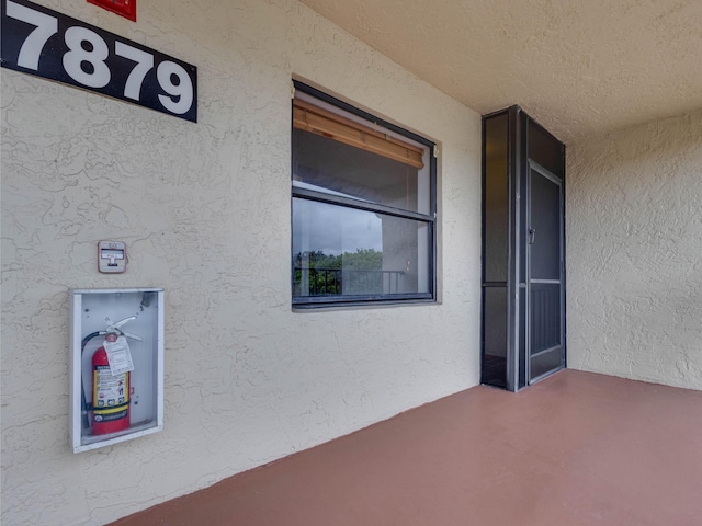 entrance to property with stucco siding