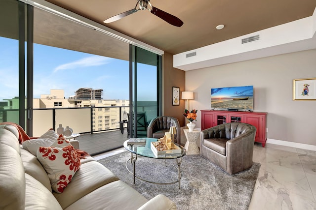 living room with ceiling fan and expansive windows