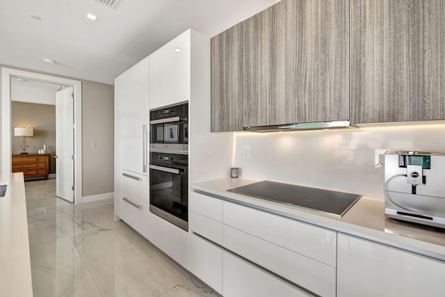 kitchen featuring white cabinets, black appliances, and extractor fan