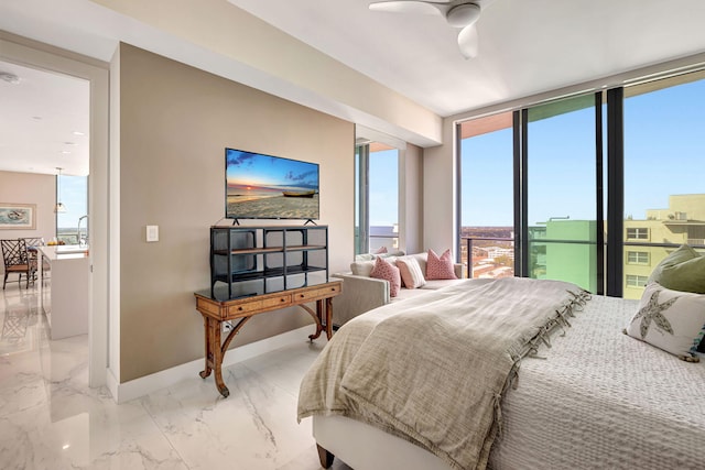 bedroom featuring ceiling fan, expansive windows, and sink