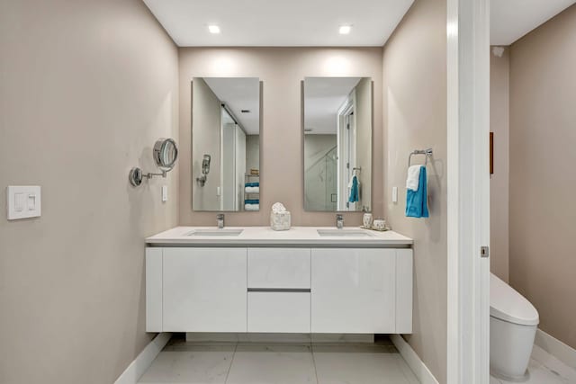 bathroom featuring vanity and toilet