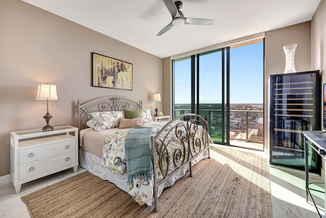 bedroom featuring access to exterior, expansive windows, multiple windows, and ceiling fan