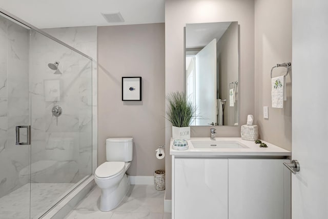 bathroom featuring vanity, a shower with shower door, and toilet