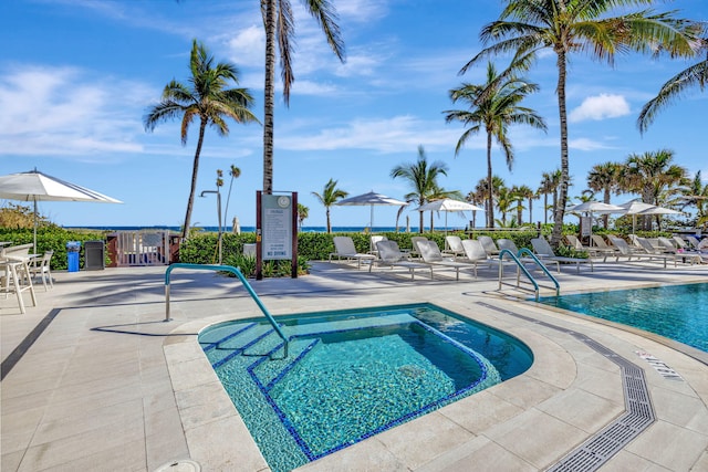 view of swimming pool with a patio and a hot tub