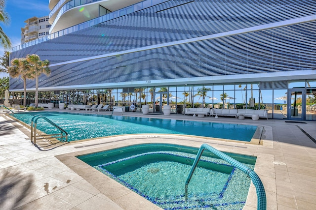 view of pool featuring a patio area and a community hot tub