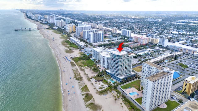 drone / aerial view featuring a water view and a view of the beach