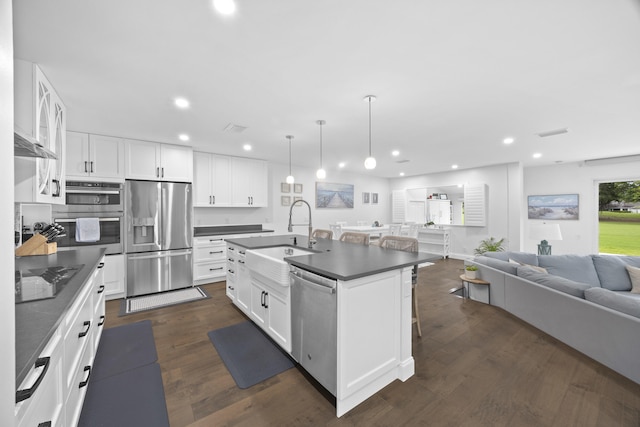 kitchen with white cabinets, dark hardwood / wood-style flooring, stainless steel appliances, and sink