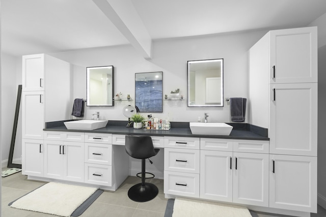 bathroom featuring beam ceiling, tile patterned flooring, vanity, and walk in shower