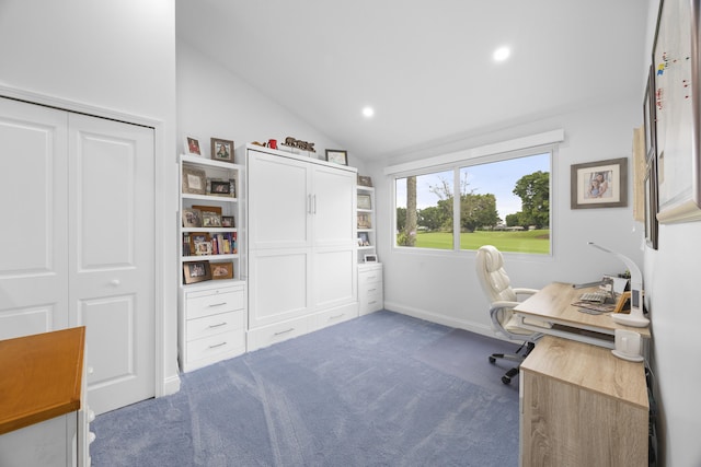 carpeted home office with vaulted ceiling