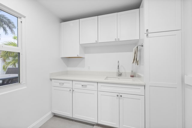 kitchen with white cabinetry and sink