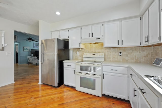 kitchen featuring white cabinetry, light hardwood / wood-style flooring, stainless steel refrigerator, double oven range, and decorative backsplash