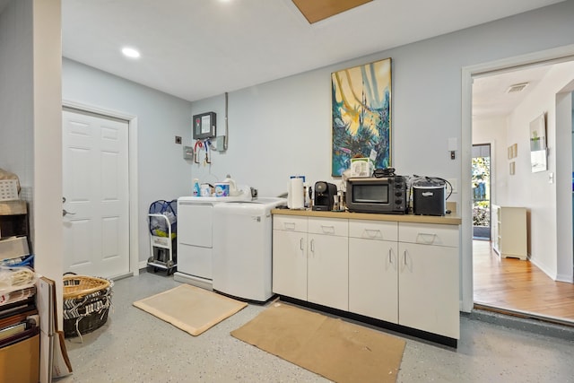 clothes washing area featuring independent washer and dryer