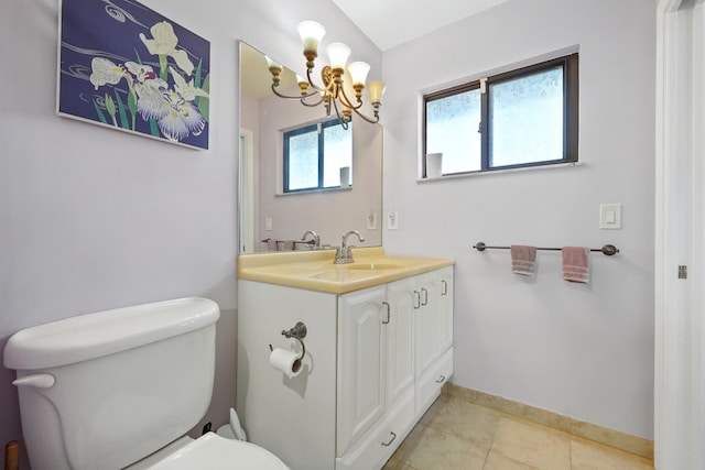 bathroom with vanity, toilet, tile patterned flooring, and a notable chandelier