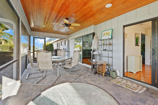 sunroom with wood ceiling and ceiling fan