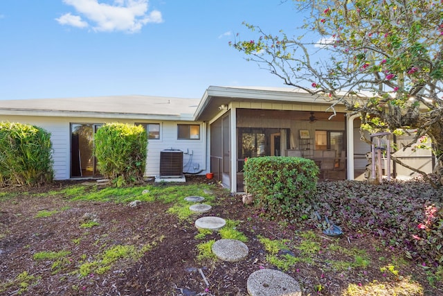 rear view of property with central AC unit, a sunroom, and ceiling fan