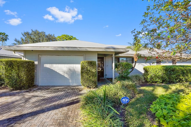 ranch-style home featuring a garage