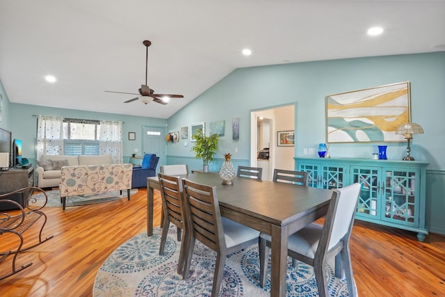 dining area with vaulted ceiling, ceiling fan, and light hardwood / wood-style floors