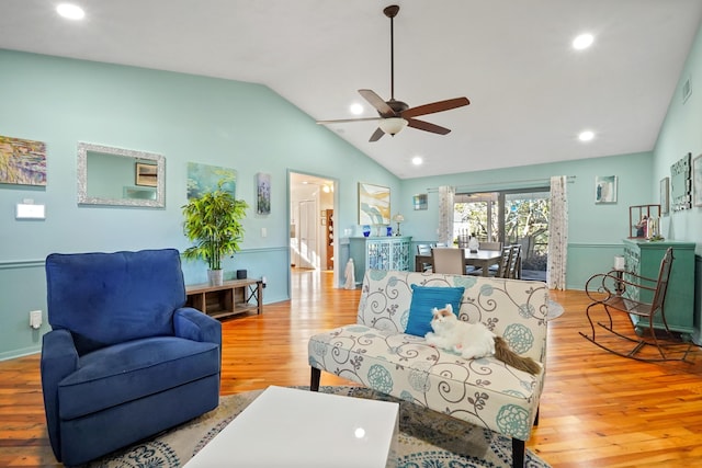 living room with lofted ceiling, light hardwood / wood-style flooring, and ceiling fan