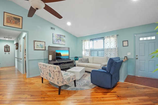 living room featuring ceiling fan, lofted ceiling, and light hardwood / wood-style floors