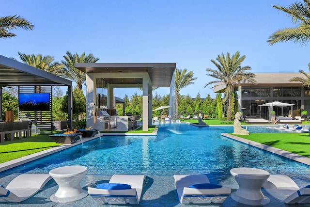 view of swimming pool with a yard, pool water feature, and a patio