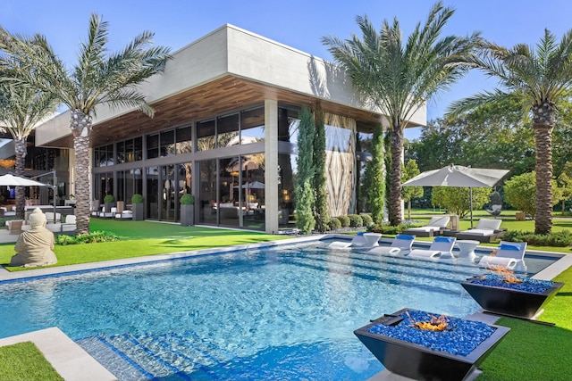 view of swimming pool featuring a yard and a patio area