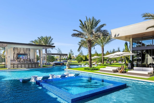 view of pool with a jacuzzi and a bar