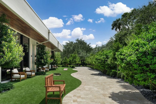 view of home's community with a yard, a patio, and an outdoor hangout area