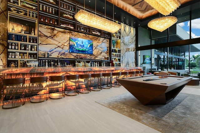 recreation room with bar area and tile patterned floors