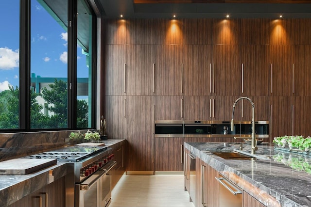 kitchen with high end stove and dark stone counters