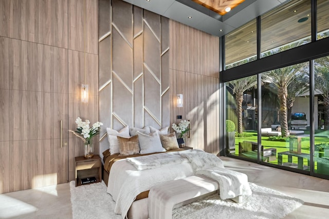 bedroom featuring a towering ceiling and concrete floors