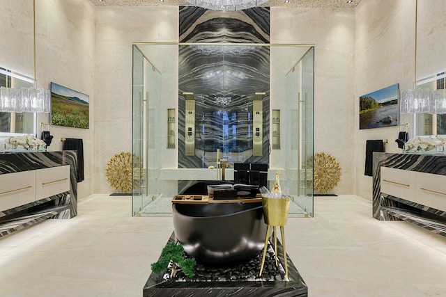 bathroom with concrete floors and a high ceiling