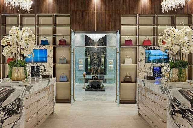 walk in closet featuring a notable chandelier